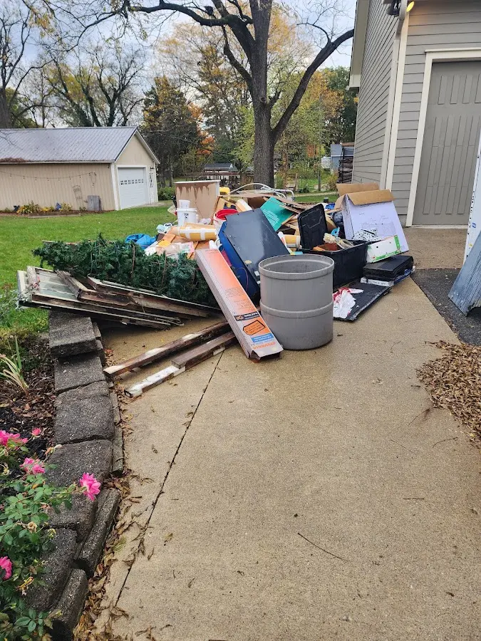 Dumpster being loaded with debris for Estate Cleanout Dumpster Rental in Franklin Park